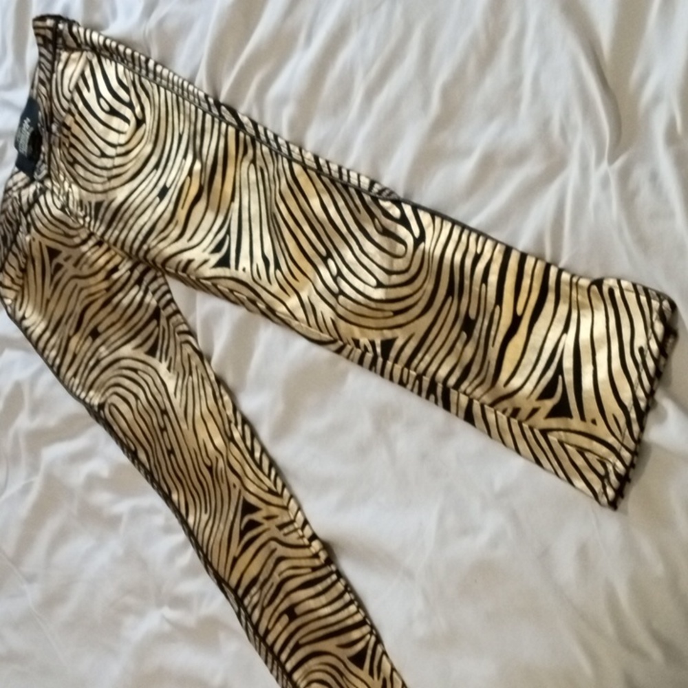Jeans with fingerprint graphic in gold